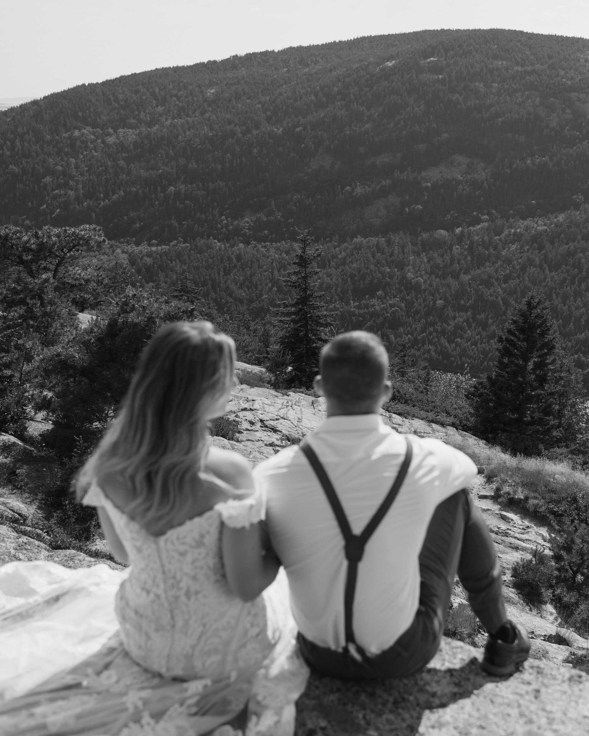 elopement couple sitting on a mountain in acadia national park after saying their private vows