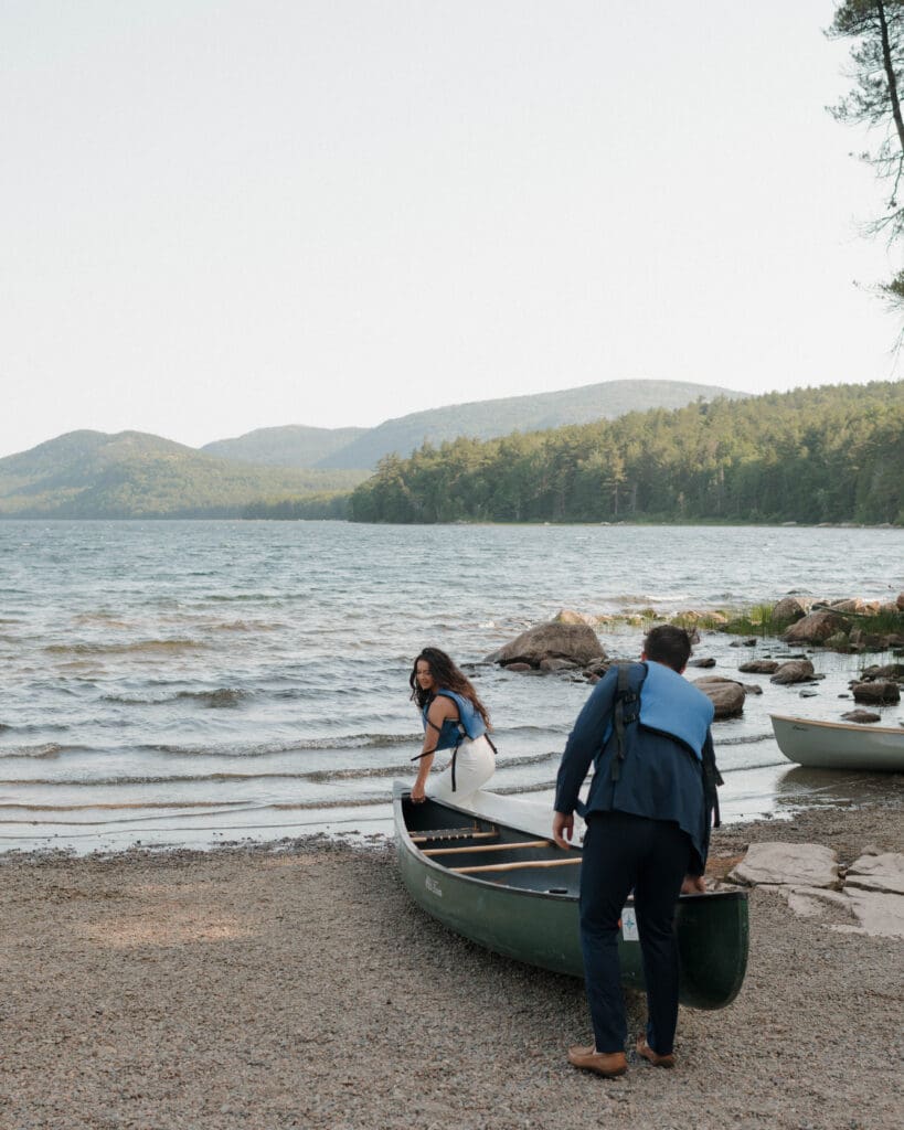 couple canoeing on eagle lake in acadia national park before their elopement ceremony
