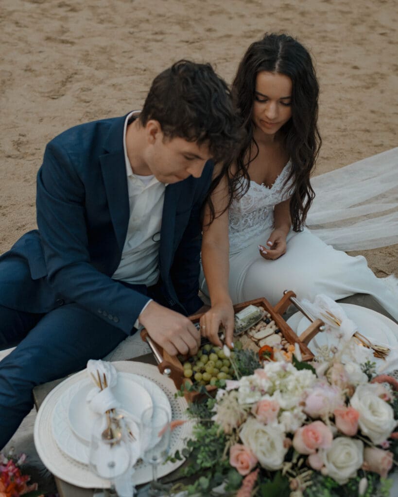 elopement couple sharing a picnic at sand beach in acadia national park