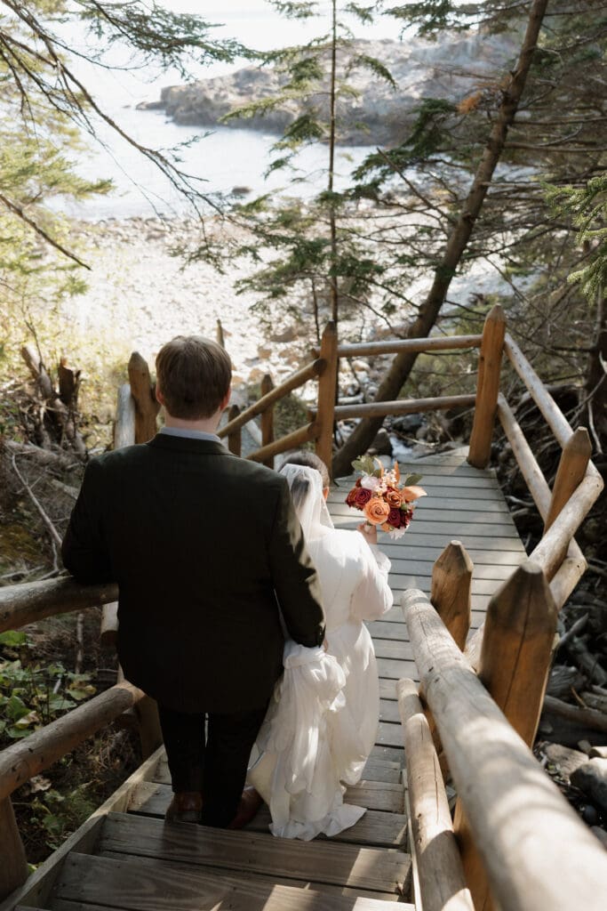 bride and groom walking down stairs to hunters beach