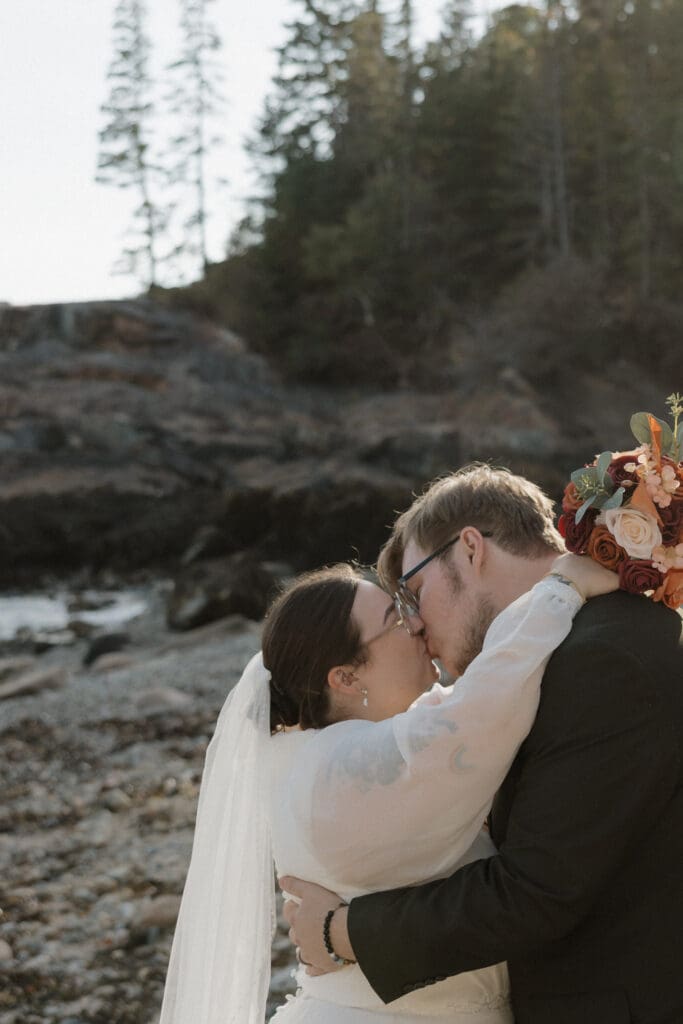 bride and groom kissing on hunters beach