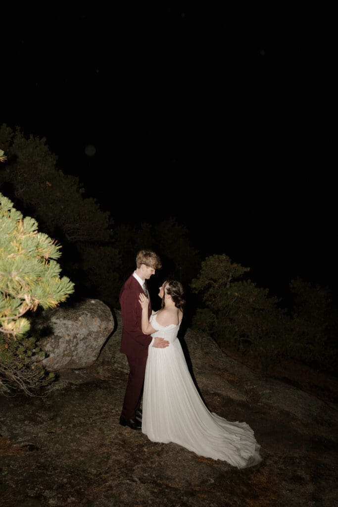 couple on top of a mountain in acadia national park in the dark